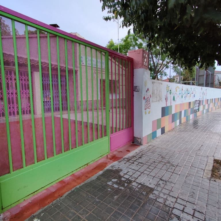 Entrada de la sede de ADSI, con vallado y muro decorados en colores vivos